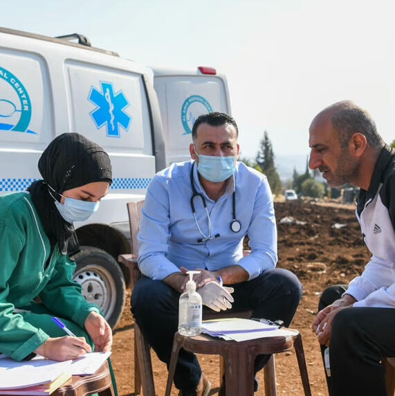 Relief International volunteer help aid recipient