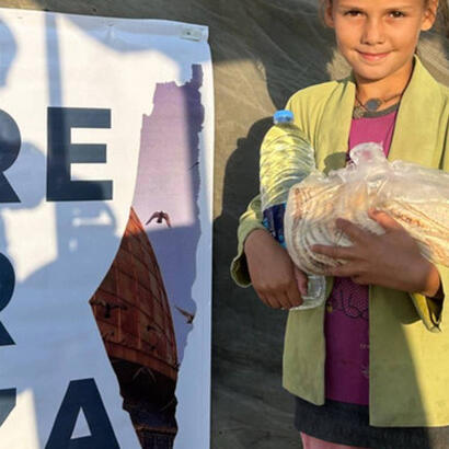 A child from Gaza receiving bread and water from Chuff volunteers