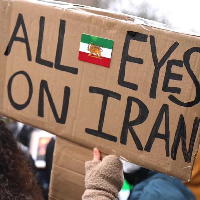a cardboard cutout with “All Eyes on Iran” written on it